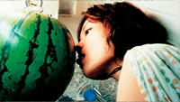 Image of woman licking watermelon